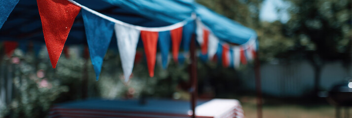 Colorful red, white, and blue bunting decorates large outdoor patio area