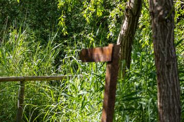 Rusty signpost showing the way in lagoa pequena interpretive space, sesimbra, portugal