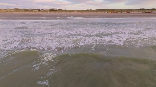 Low Drone Flyover Following Waves from Sea to Shore with Bird | FlyLens 4K