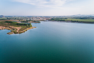 Aerial View of a Calm Reservoir Surrounded by Fields