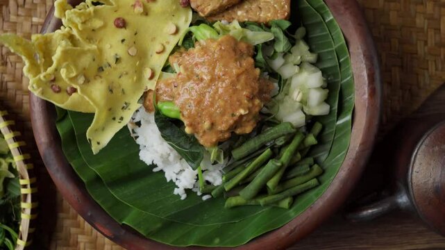 Pecel Presentation in Clay Plate with Traditional Ambience