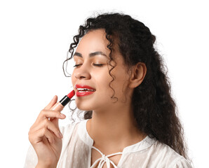 Obraz premium Beautiful young African-American woman applying red lipstick on white background