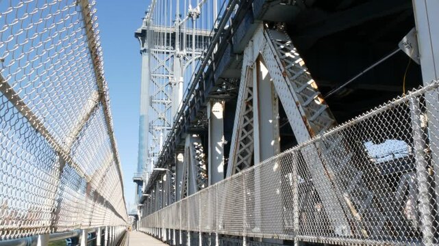Manhattan Bridge to Brooklyn Dumbo. New York City symbol, USA travel destination. Architecture of United States, tourist landmark. Cable-stayed bridge. Pedestrian path perspective.