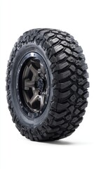 Naklejka premium Black off-road tire with rugged pattern and metallic rim, isolated on white studio background