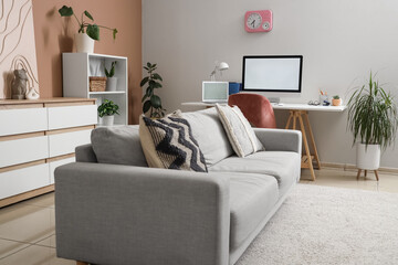 Interior of living room with sofa and workplace