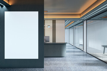 Blank vertical poster mockup on dark wall in modern office interior near reception desk with glass partitions and ceiling lights. 3D Rendering