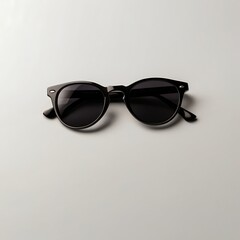 Elegant Sunglasses: Minimalist composition of a pair of sleek, black sunglasses, casting a shadow, perfect for concepts related to fashion and vision.