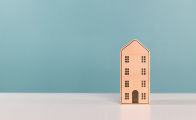Housing, home, condo, mortgage, real estate investment and residential building concept. Miniature cardboard box house on the table with copy space