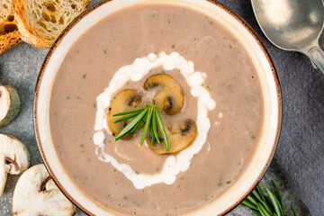 Delicious and healthy mushroom soup on stone background