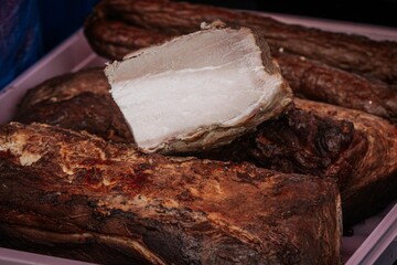 Sliced smoked pork loin showcasing a tender, juicy interior and a seasoned, crispy exterior, ideal for food visuals or product showcases.