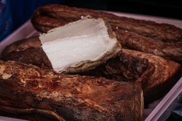 Sliced smoked pork loin showcasing a tender, juicy interior and a seasoned, crispy exterior, ideal for food visuals or product showcases.