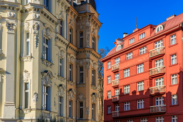 Elegant architectural contrast of ornate historic buildings in red and yellow facades