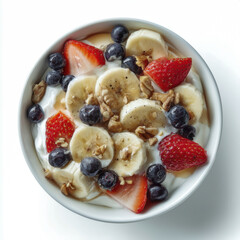 Fresh fruit yogurt bowl with sliced bananas strawberries blueberries and chopped nuts topped with creamy yogurt served in a white bowl