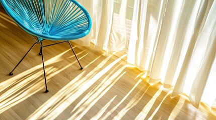 Sunlight streams through sheer curtains onto light-colored wood flooring.