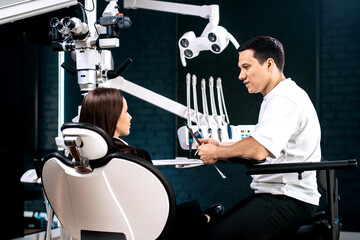 Patient at dental consultation with dentist discussing oral care and treatment in a clean, professional clinic. Concept — dental services, orthodontics, oral hygiene campaigns, healthcare education.