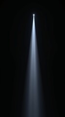 Narrow spotlight beam shining down in black space.