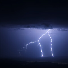 Dramatic lightning strike over a dark expanse