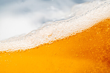 Close up bright orange Oil or beer splash texture and nature waves, Beautiful waves curve and little bubbles smooth for graphic design and background, Oil Bubbles, Soft beer bubbles, Selective focus