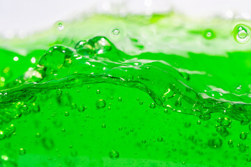 Water wave, close up of vibrant green liquid with bubbles, capturing dynamic movement and...