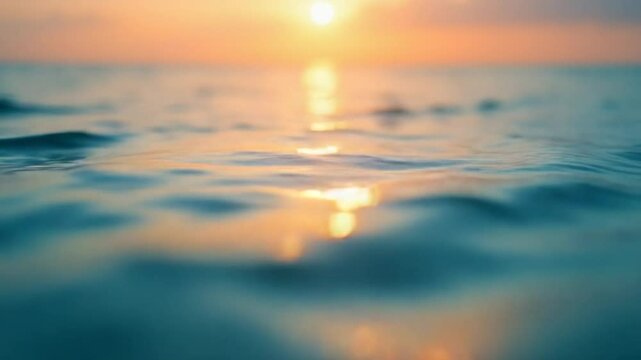 Abstract aerial nature summer ocean sunset sea and sky background. Small waves on clear water surface in motion blur with bokeh lights from sunrise. Holiday, vacation and recreational concept