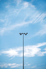 Outdoor stadium lamp post against blue sky