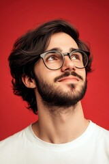 Obraz premium A strong and graceful male displaying confidence. Creative of style for aging men. Trendy men's wavy bob haircut - midlife white man with black hair. Red solid background.