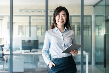 40s years old mature Asian business leader manager woman looking at camera. Smiling businesswoman...
