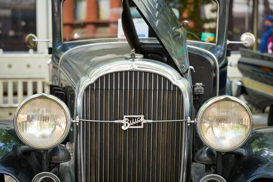 Germany Berlin May 11, 2025. Buick Vintage Car Front. The front of a historic Buick with the radiator cap open reveals classic headlights and an ornate grille. The shiny logo and lines convey a nostal