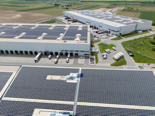 Logistics centers with solar panels on roofs. Aerial view