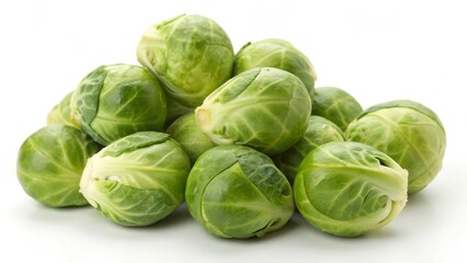 Obraz premium Fresh brussels sprouts stacked together on a white background.