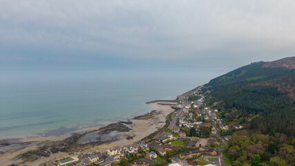 Aerial view of coast of Irish Sea and Mourne Mountains in Newcastle, Northern Ireland. Drone photo of Coastal City and water. 