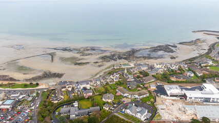Aerial view of coast of Irish Sea and Mourne Mountains in Newcastle, Northern Ireland. Drone photo of Coastal City and water. 