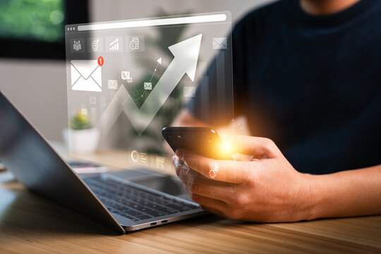 Businessman using smartphone and laptop with digital marketing analytics dashboard, email notification, financial growth graph, data visualization, business communication and technology concept