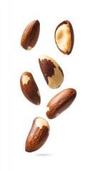 Obraz premium Floating Brazil Nuts On White Background Close Up Photography Of Brown And Beige Nuts