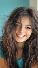 Portrait of smiling young woman with wavy brown hair and natural look