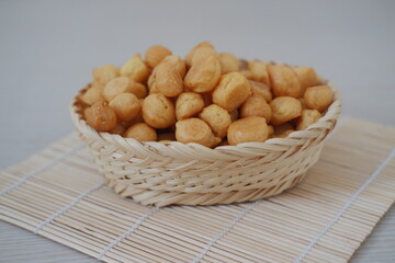 Close-up of Savory Puff Pastry Snacks in a Woven Basket