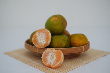 Close-up of Mandarin Oranges in a Wooden Bowl