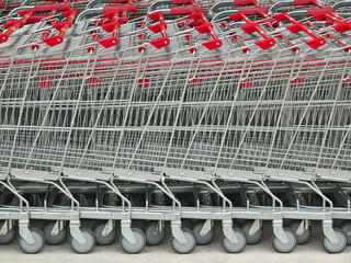 A row of shopping carts is neatly lined up in a straight row