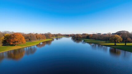 Scenic autumn waterway with reflective trees and clear sky