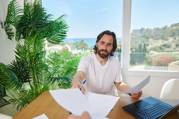 Man Working Remotely in a Tropical Inspired Home Office Setting