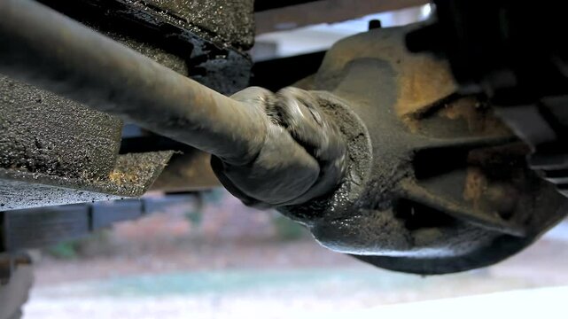 Oily Front Driveshaft Being Turned Slowly