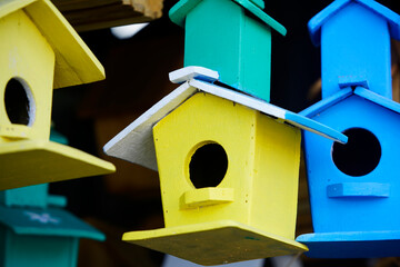 Colorful Wooden Birdhouses Hanging in a Garden Setting