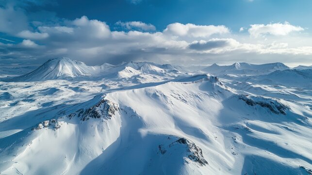 A dramatic aerial view of a high-altitude plateau covered in snow