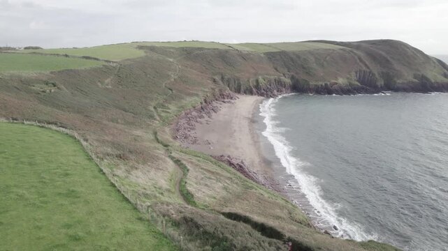 Beautiful landscape on the bank of sea view on the land of beaches on cloudy day ,panoramic curve shot , Wales UK