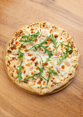 Pizza with Arugula on Wooden Background