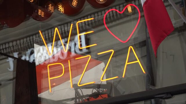 Stockholm, Sweden A We Love Pizza sign in a pizzeria window