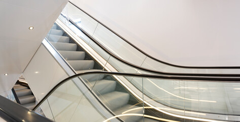 Escalators or moving staircases. Motion blur on the moving metal stairs