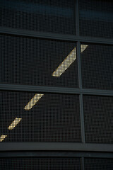 Reflections and patterns of light on a modern industrial building at dusk
