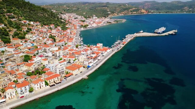 Tracking aerial shots of the coastal town and harbour of Gytheio, Greece