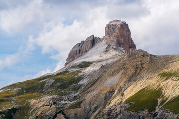 Famous mountain trio Tre Cime di Lavaredo, Drei Zinnen, under bright sky in Italian Dolomites. Scenic and peaceful landscape known for its hiking trails and breathtaking alpine views.